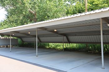 A parking structure with a roof and pillars.